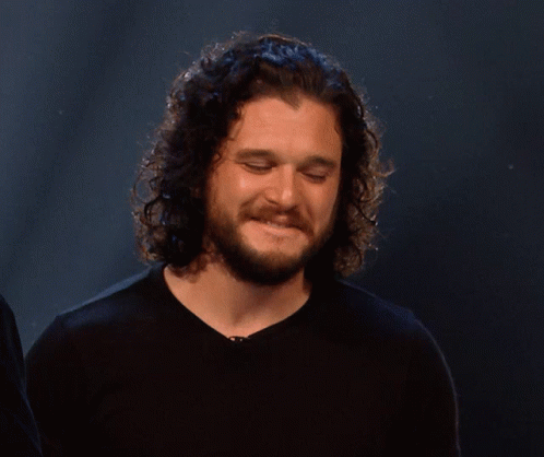 Man With Curly Hair and Beard Smiling