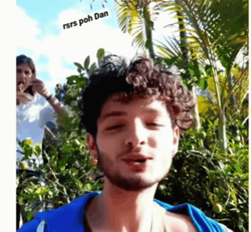 Man With Curly Hair and Blue Shirt Says Rsrs Poh Dan