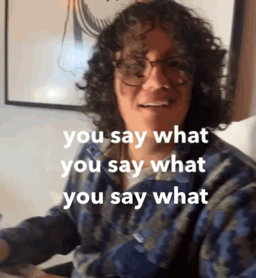 Man with Curly Hair and Glasses Saying What