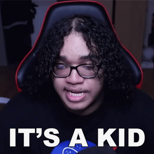 Man with Curly Hair and Glasses Sitting