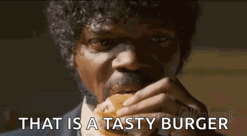 Man with Curly Hair and Mustache Eating Tasty Burger