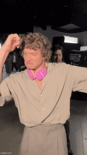 Man with Curly Hair and Pink Headphones