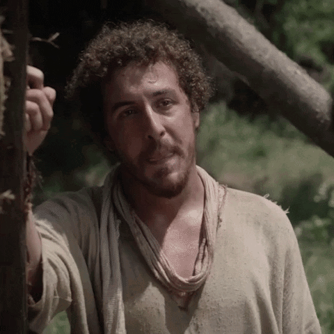 Man with Curly Hair and Scarf Next to Tree