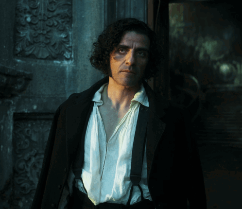 Man With Curly Hair And Suspenders In Front Of Building GIF