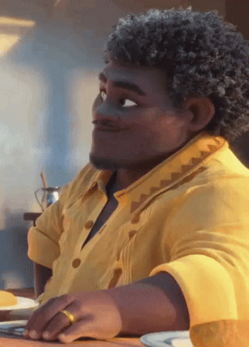 Man with Curly Hair and Yellow Shirt Sitting