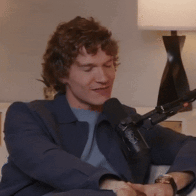 Man with Curly Hair at NBC Microphone