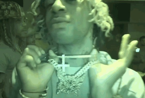 Man with Curly Hair Cross Necklace Smoking