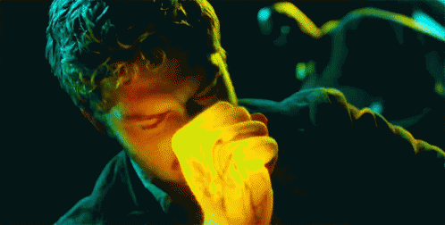 Man with Curly Hair Eating Yellow Item