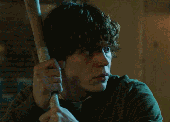 Man With Curly Hair Holding Baseball Bat