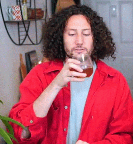 Man With Curly Hair Holding Beer