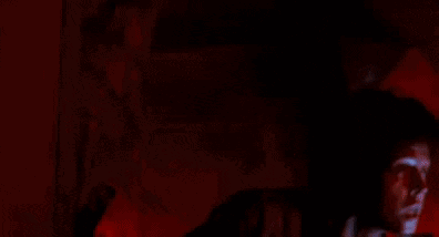 Man with Curly Hair Holding Flashlight