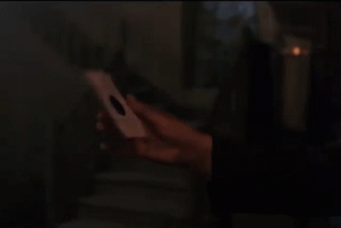 Man With Curly Hair Holding Paper GIF
