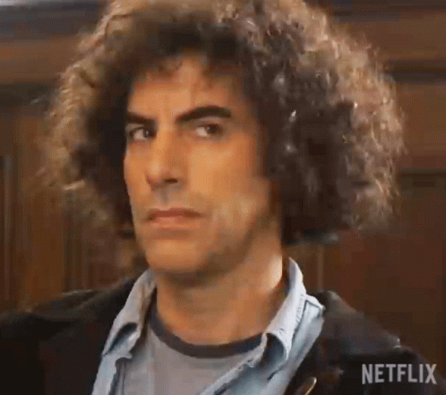 Man With Curly Hair in Denim Shirt and Jacket