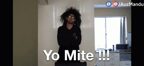 Man with Curly Hair in Front of Yo Mite Wall