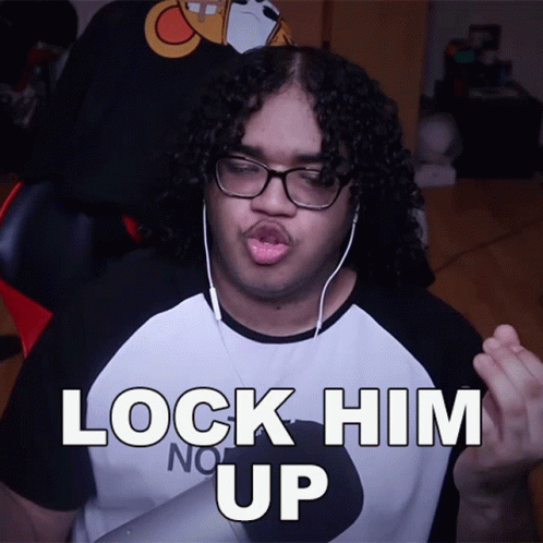 Man With Curly Hair in Headphones and Lock Him Up Shirt