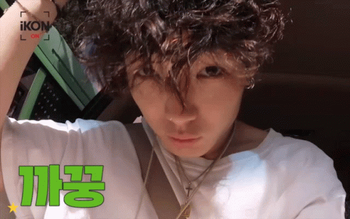 Man With Curly Hair In White Shirt Saying Ikon GIF