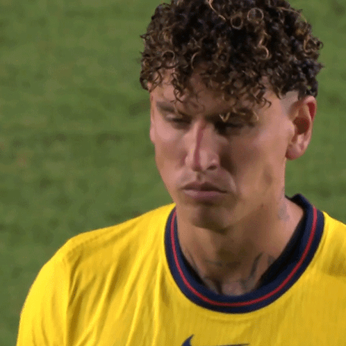 Man with Curly Hair in Yellow Nike Shirt