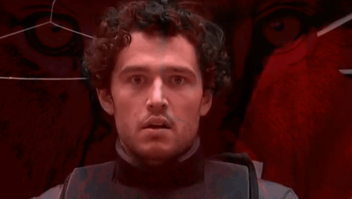 Man With Curly Hair Looking At Camera GIF
