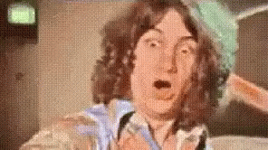 Man With Curly Hair Making Funny Face GIF