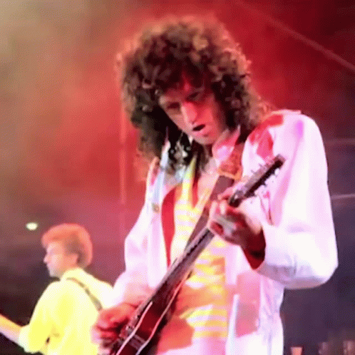 Man with Curly Hair Playing Guitar