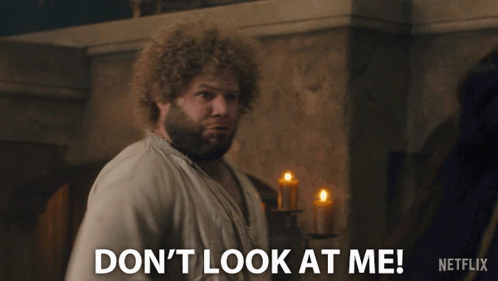 Man with Curly Hair Saying Don't Look At Me