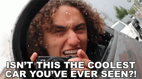 Man with Curly Hair Taking Photo of Cool Car