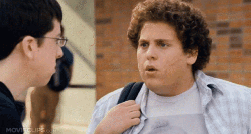 Man with Curly Hair Talking to Man with Glasses