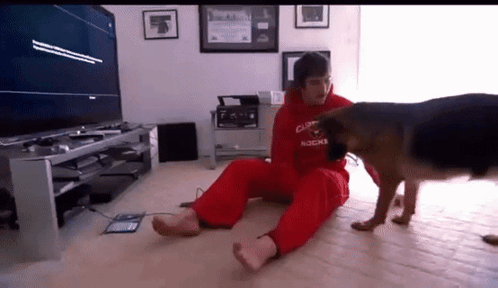 Man with Dog in Red Hoodie Saying Duke