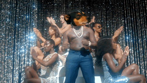 Man With Dog's Head Surrounded by Women