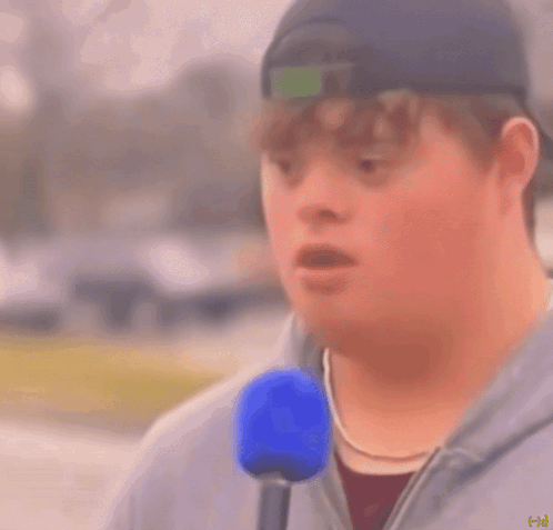 Man With Down Syndrome Holding Blue Microphone Saying Mayonnaise GIF