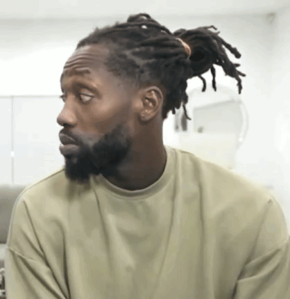 Man With Dreadlocks And Beard Looking Sideways GIF