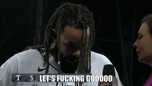 Man with Dreadlocks and Beard Saying Lets Go
