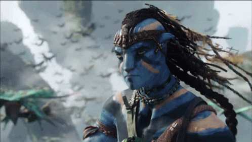 Man With Dreadlocks And Blue Face Standing Before Birds GIF