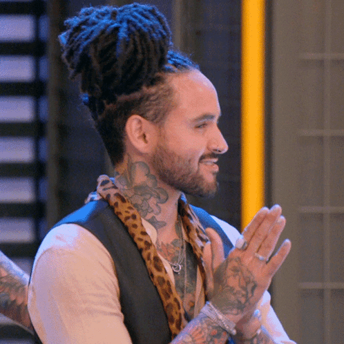 Man with Dreadlocks and Leopard Print Scarf Clapping