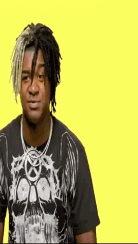 Man With Dreadlocks and Skull Shirt on Yellow Background