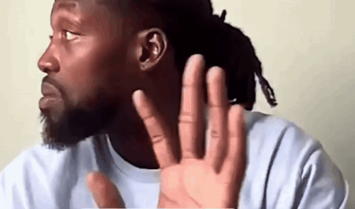 Man With Dreadlocks Covering Ear GIF