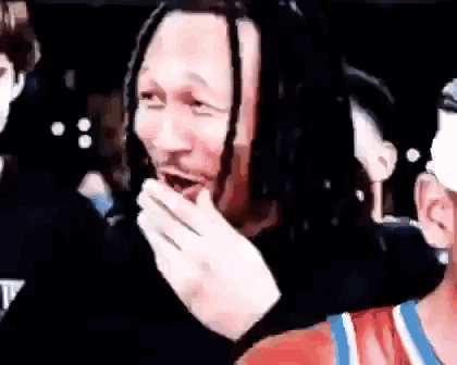 Man with Dreadlocks Covering Mouth