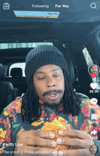 Man with Dreadlocks Eating Hamburger
