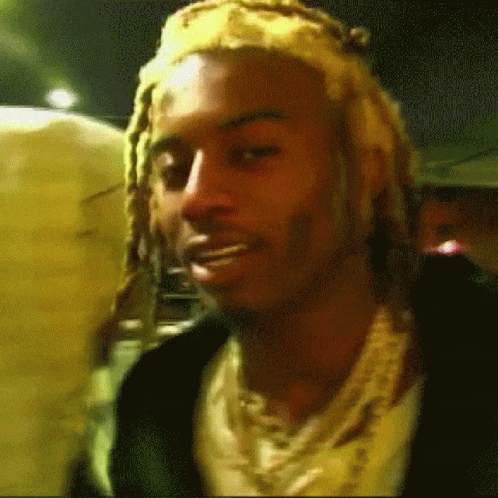 Man With Dreadlocks, Headband, and Necklace
