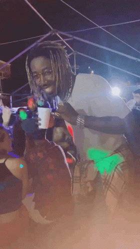 Man With Dreadlocks Holding Cup In Crowd GIF