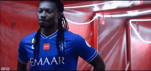 Man with Dreadlocks in Blue Emaar Shirt