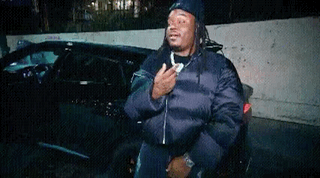 Man With Dreadlocks In Front Of Car GIF