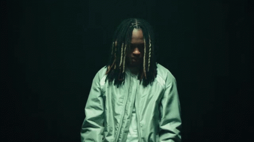 Man With Dreadlocks in Green Jacket and White Shirt
