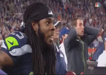 Man With Dreadlocks in Nike Headband Watching Football