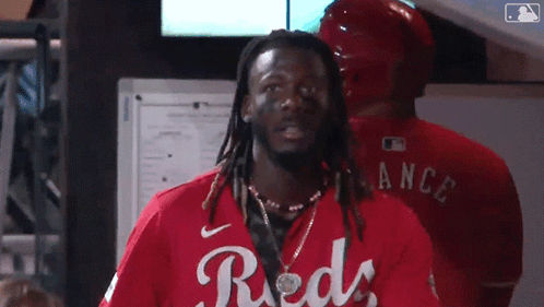 Man With Dreadlocks In Red Shirt Saying Reds GIF