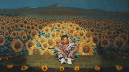 Man With Dreadlocks In Sunflower Field GIF