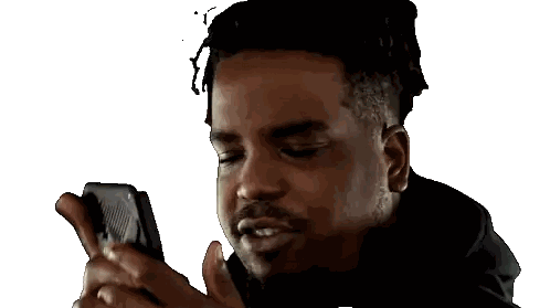 Man with Dreadlocks Looking at Cellphone