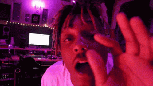Man With Dreadlocks Making Funny Face Under Purple Lights