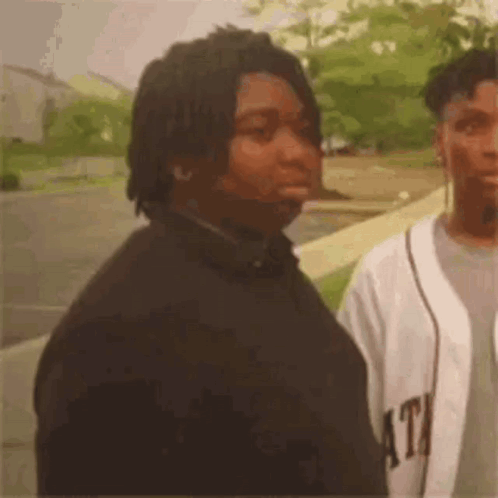 Man with Dreadlocks Next to Baseball Jersey