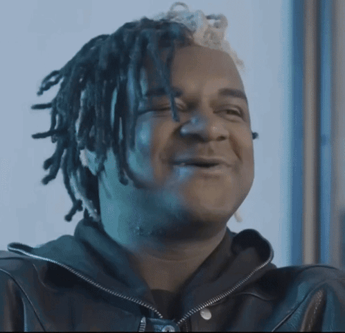 Man with Dreadlocks on Couch Holding Money Bag